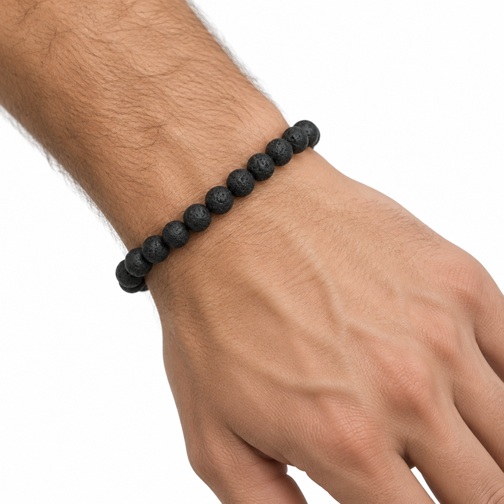 Bransoletka z czarnego kamienia lawy na nadgarstku, biale tlo